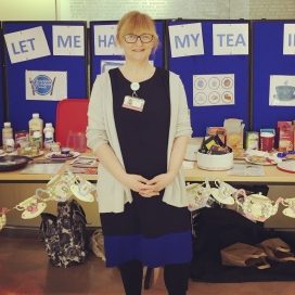 Foodchain-staff-lucy Lucy Nichols standing in front of table with tea and cakes